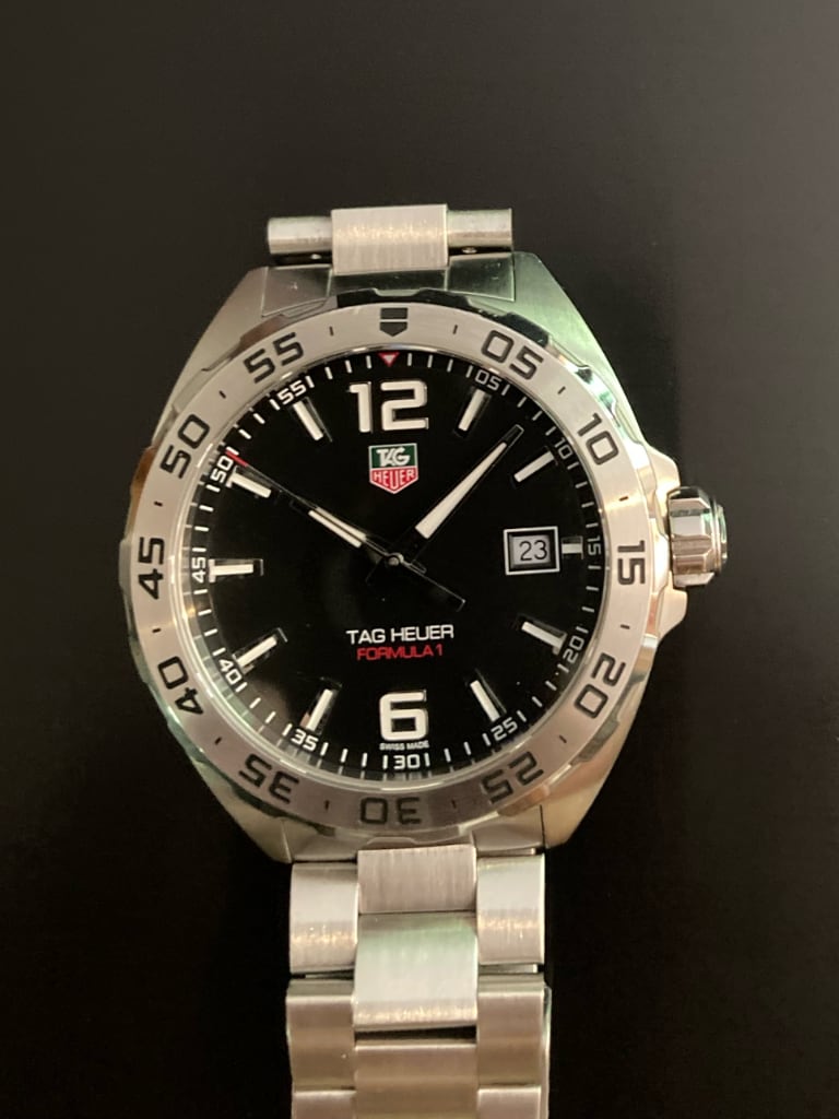 TAG Heuer Formula 1 Date WAZ1112.BA0875 angled front view showing luminous hands, date window and steel bezel