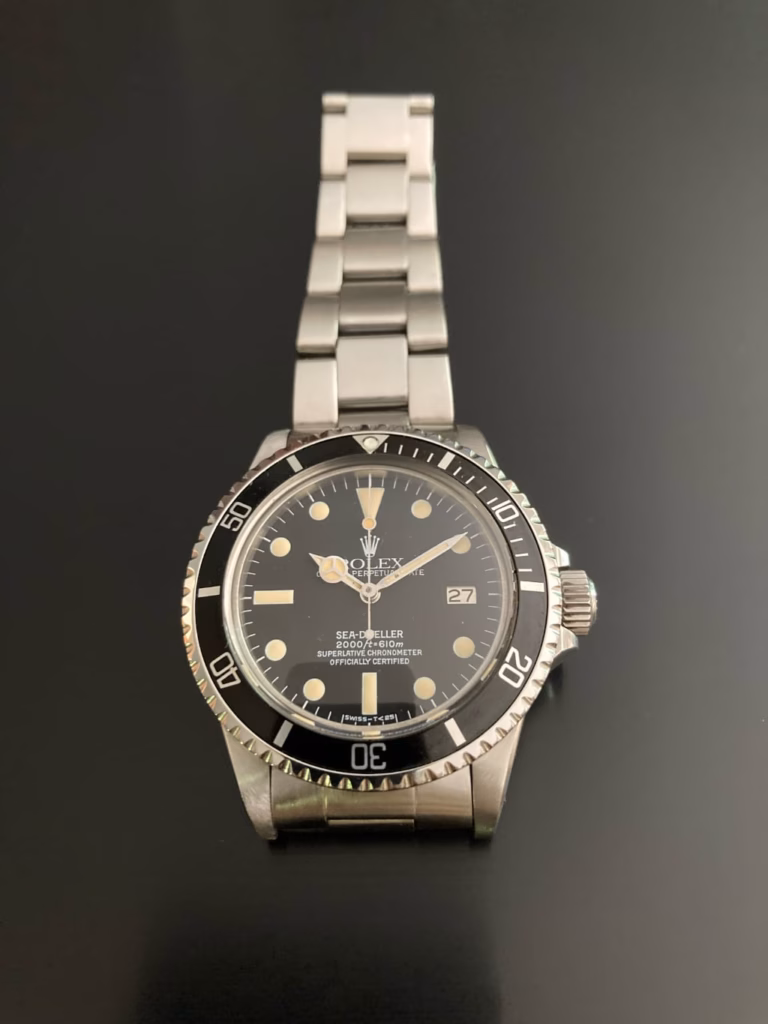Vintage Rolex Sea-Dweller Ref. 1665 (1978) front view — matte black dial, warm patinated cream lume plots and vintage-style hands, black 60-minute bezel